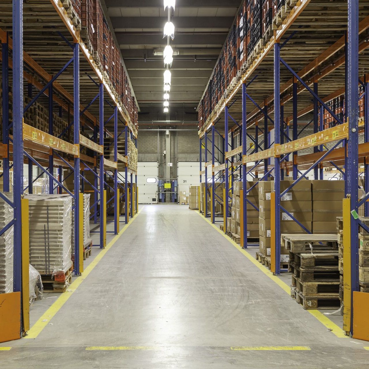 an empty warehouse with a yellow line on the floor