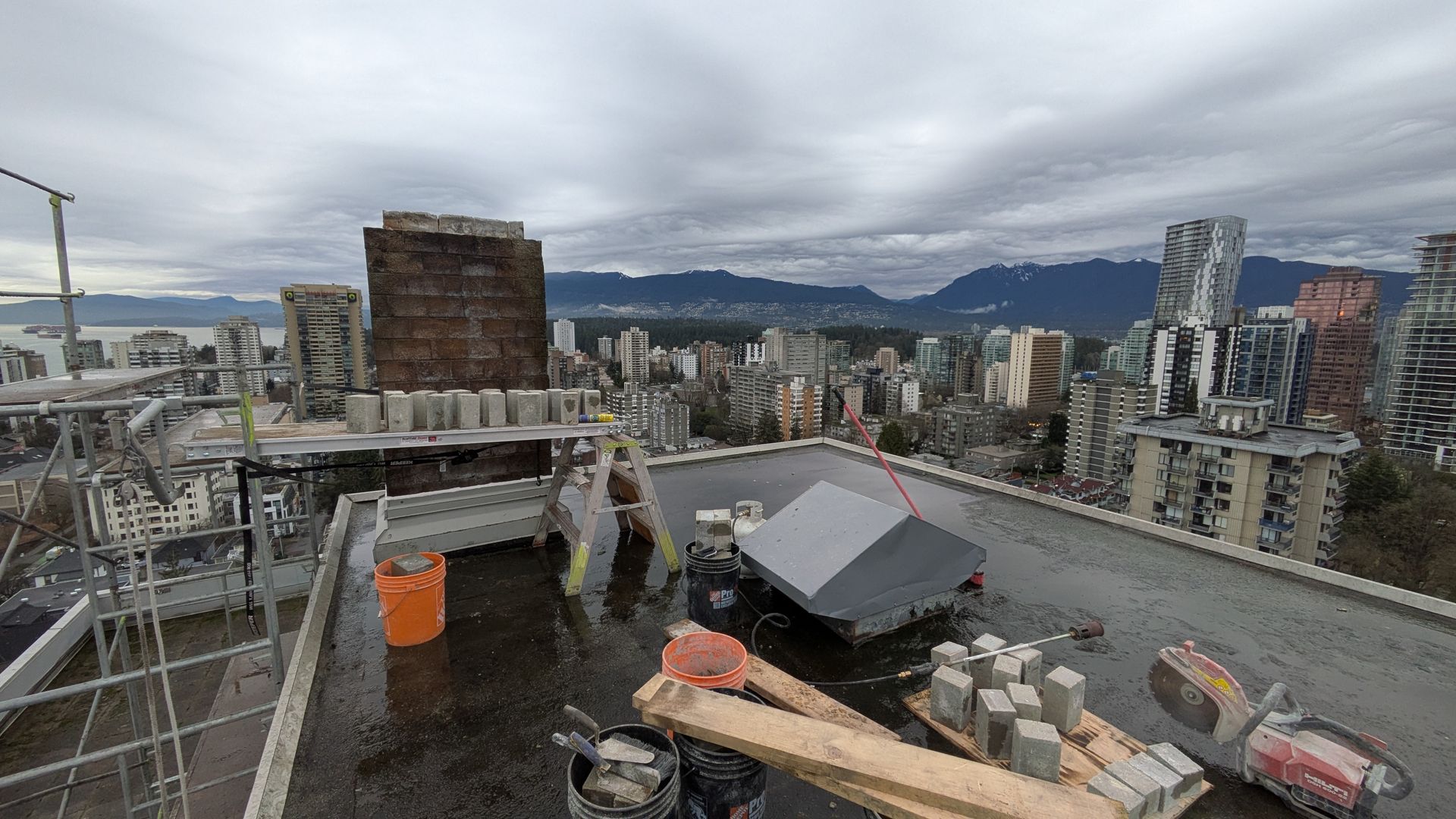 Repairing brick chimney with beautiful view of city skyline