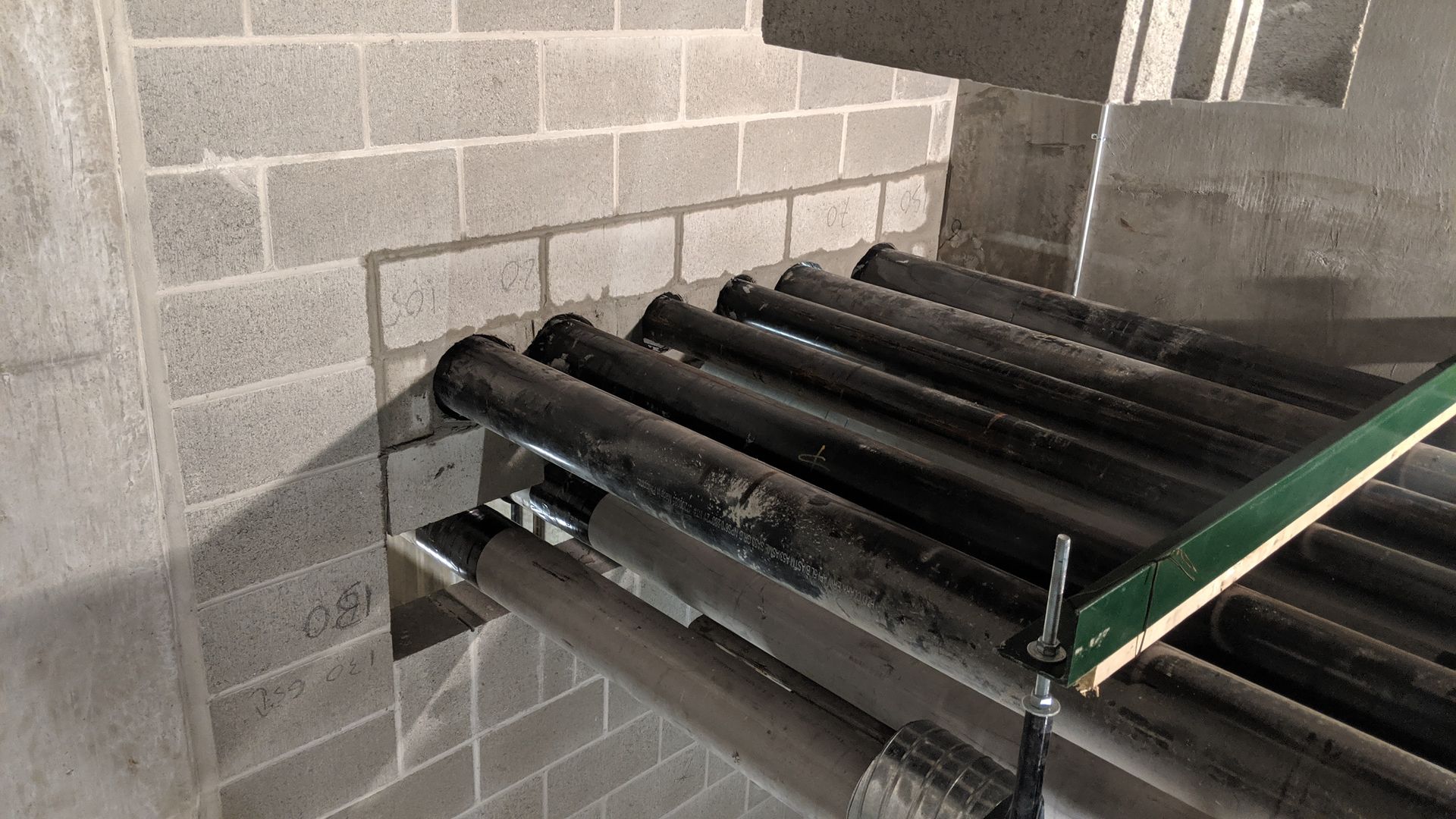 New concrete block wall constructed to pipes to go through wall