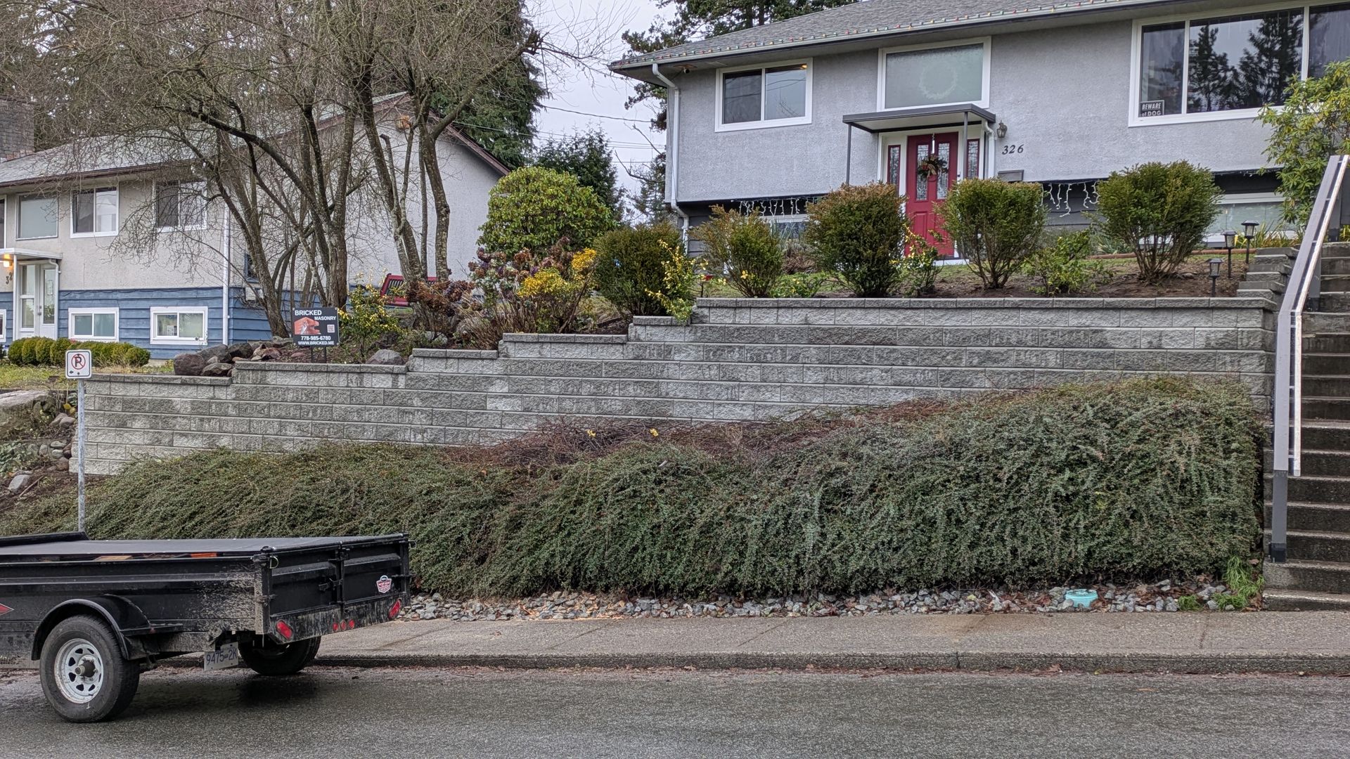 Trailer parked in front of new retaining wall
