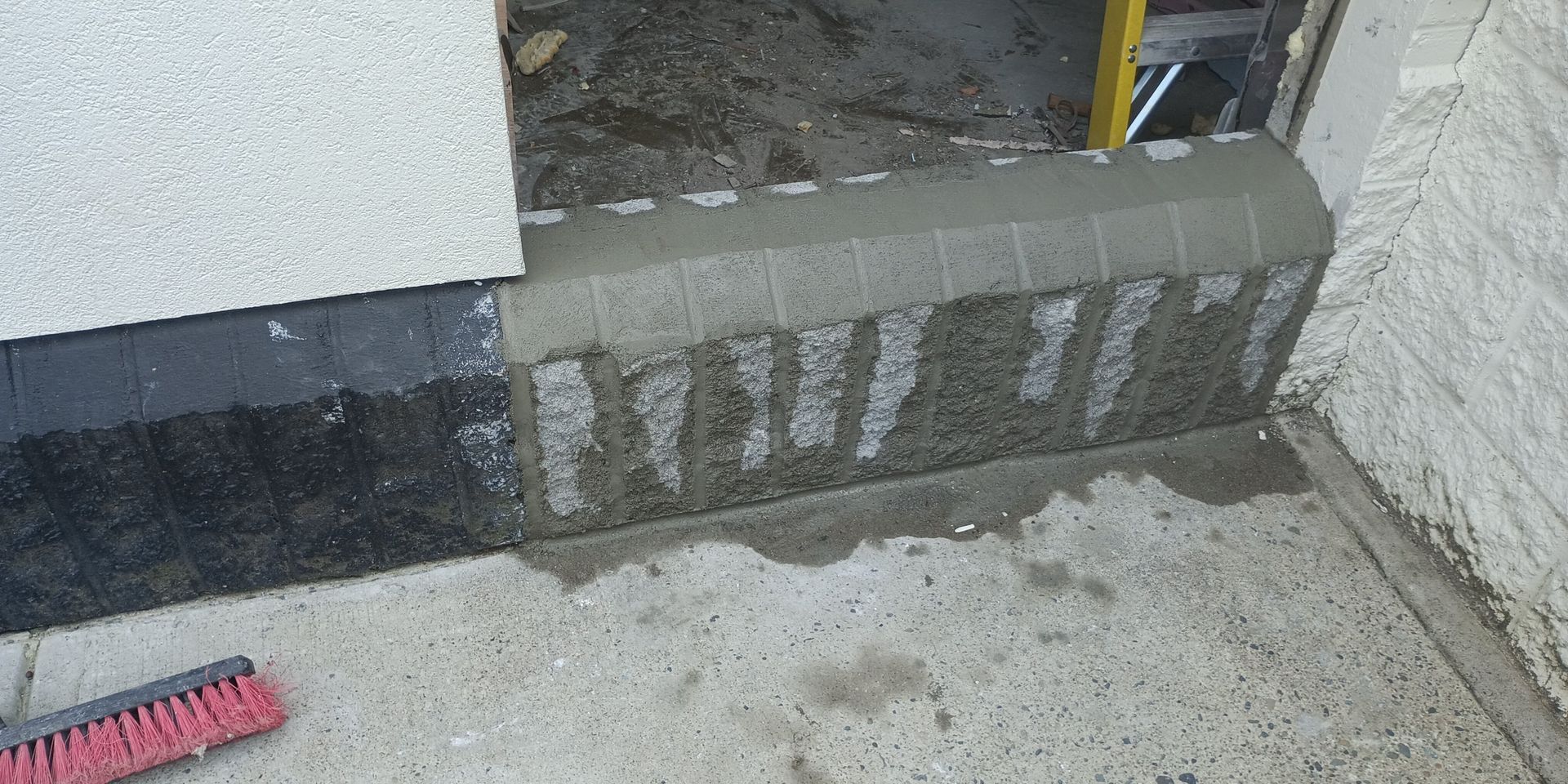 A concrete block step repaired with fresh concrete