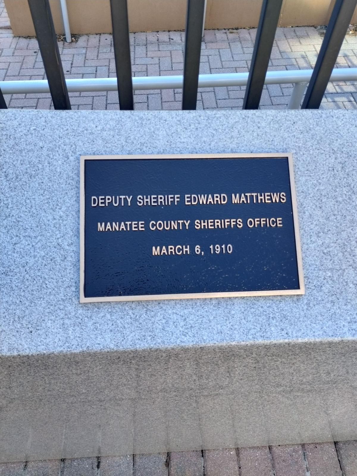 A plaque that says deputy sheriff edward matthews on it