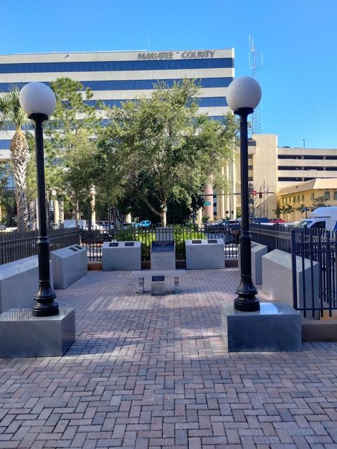 A brick walkway in front of a building that says memorial center
