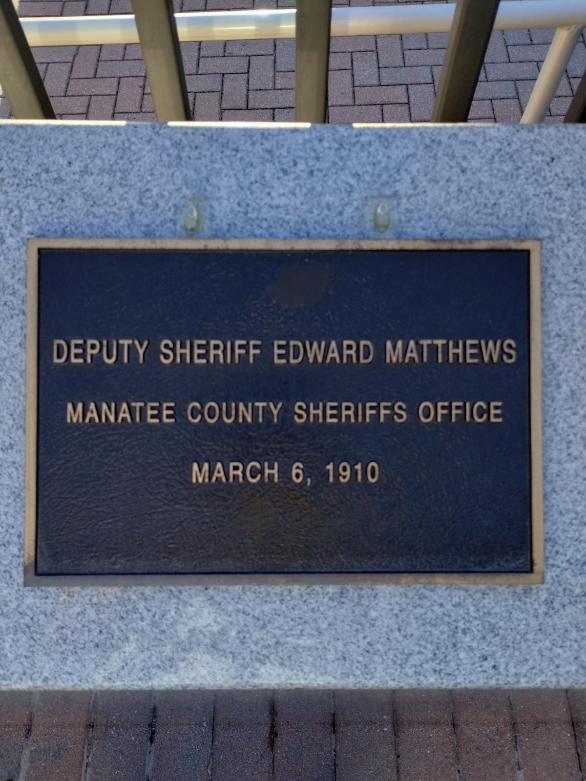A plaque that says deputy sheriff edward matthews on it