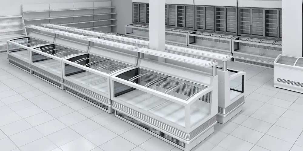 Empty refrigerated supermarket display cases in a bright, tiled grocery aisle