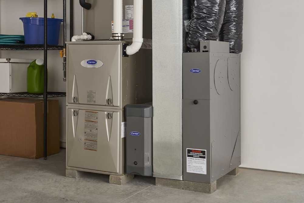 Basement utility room with two furnaces and an air conditioner beside shelves and storage bins