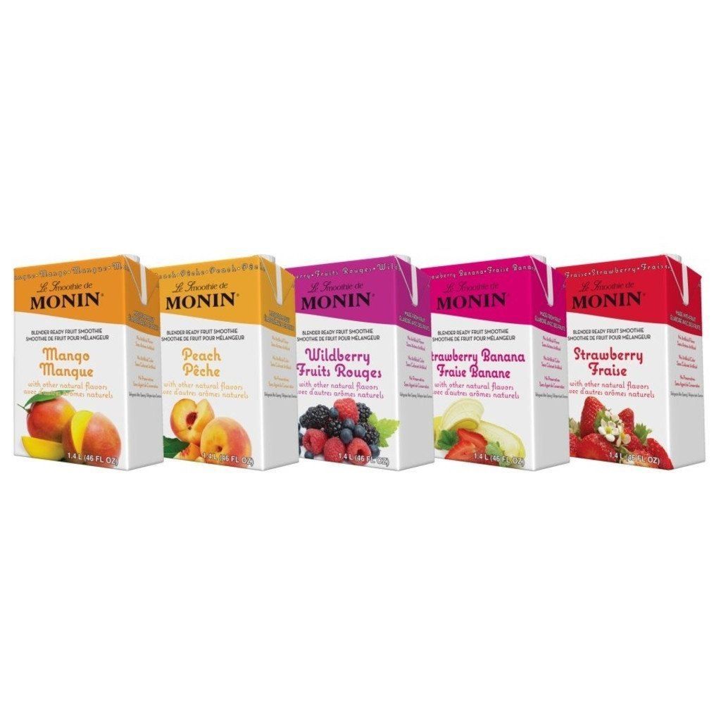 A row of monin juice boxes with different flavors on a white background.