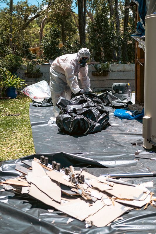 A Pile of Rocks Stacked on Top of Each Other on Wooden Pallets — Asbestos Risk Removal In Gladstone, QLD