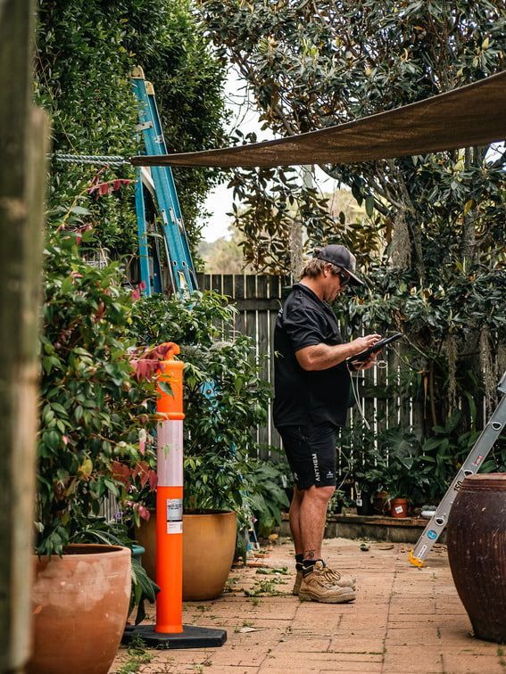 A Person Is Sitting at A Table Writing on A Piece of Paper — Asbestos Risk Removal In Gladstone, QLD