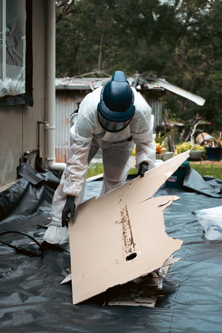 A Close up Of a Piece of Asbestos on A Concrete Surface — Asbestos Risk Removal In Gladstone, QLD