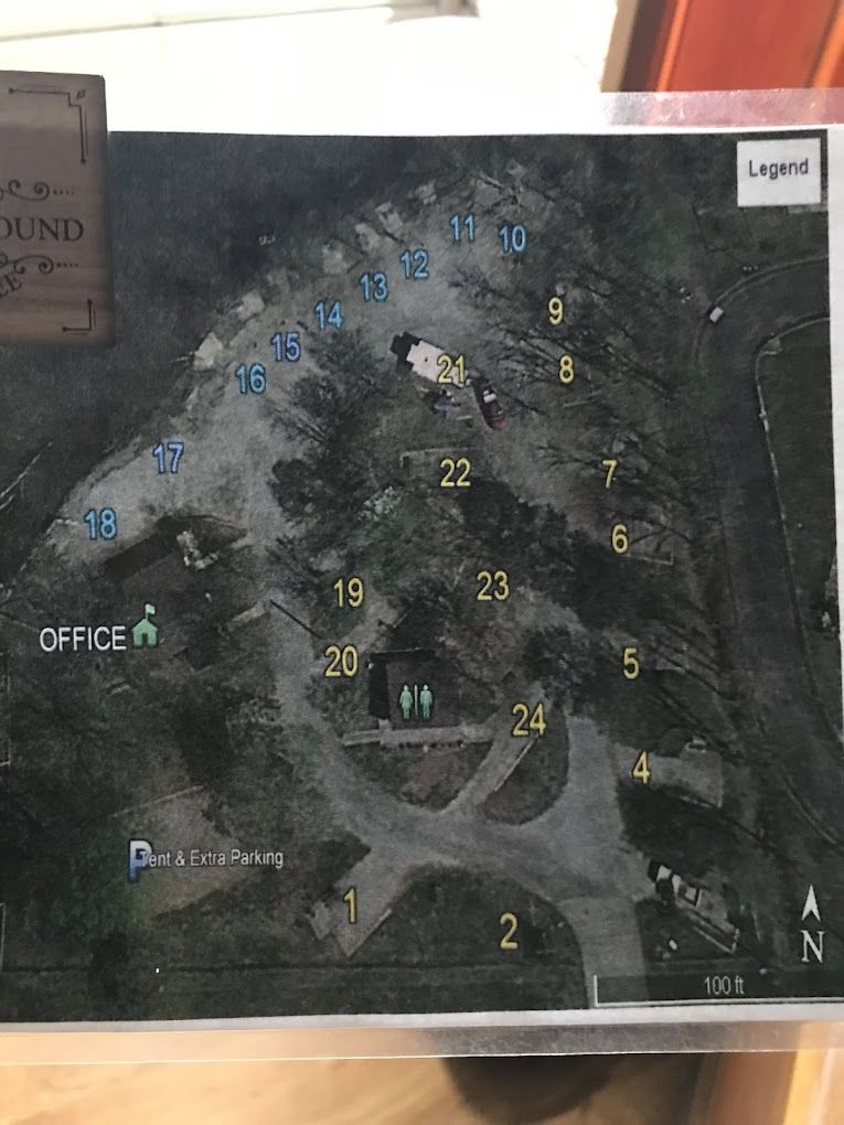 A map of a park with numbers on it is sitting on a wooden table.
