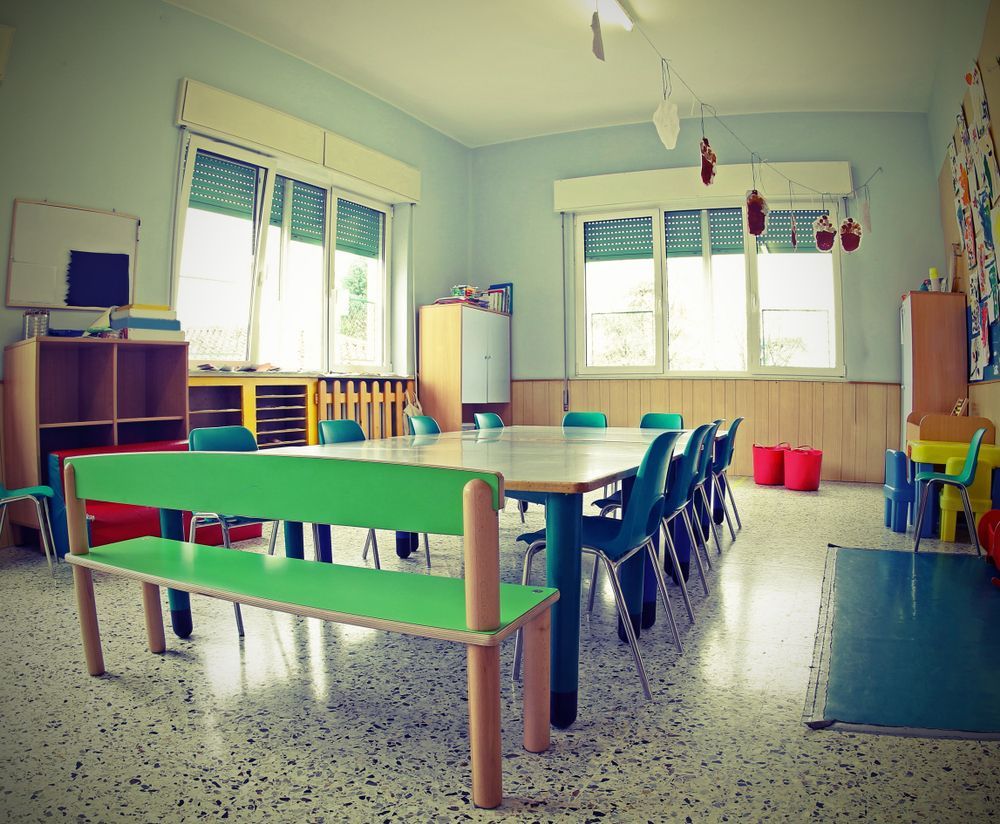 An Empty Classroom With a Large Central Table — Cyclone City Cleaners In Winnellie, NT