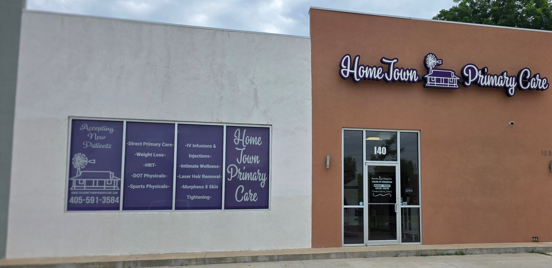 Front of HomeTown Primary Care clinic with tan and white exterior and glass entrance door