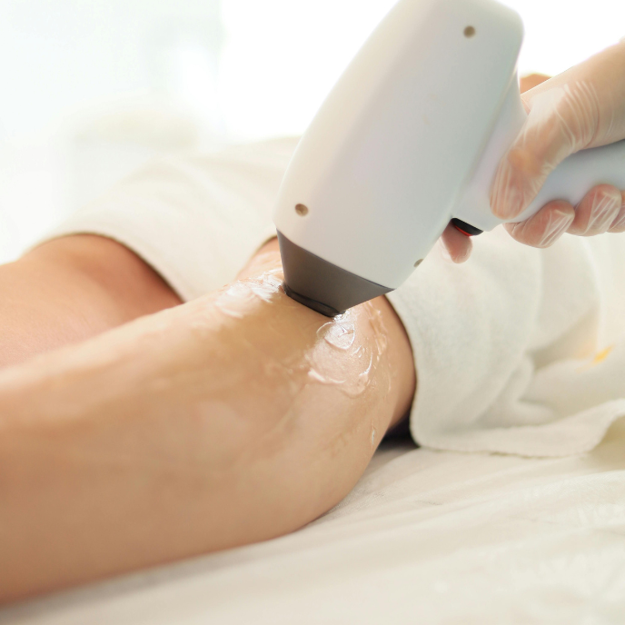 Triton laser hair removal device being used on a person's leg