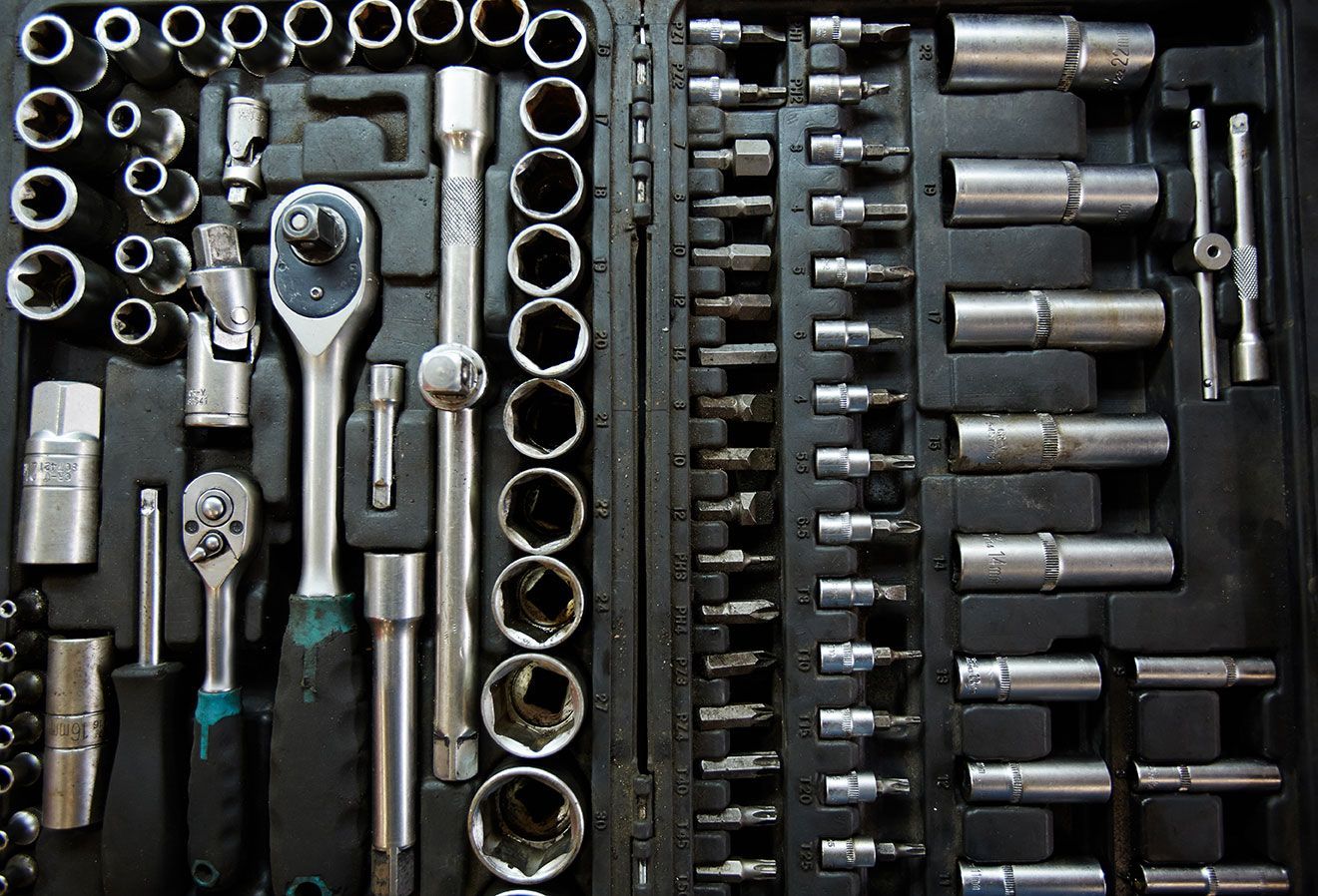 Socket wrench set with assorted sockets and ratchets arranged in a toolbox organizer