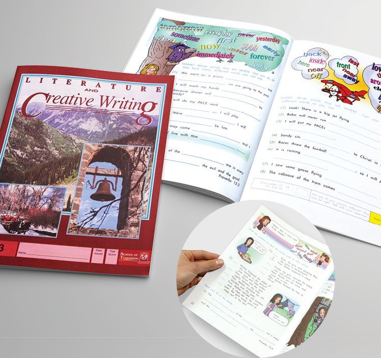 A person is holding a book titled creative writing