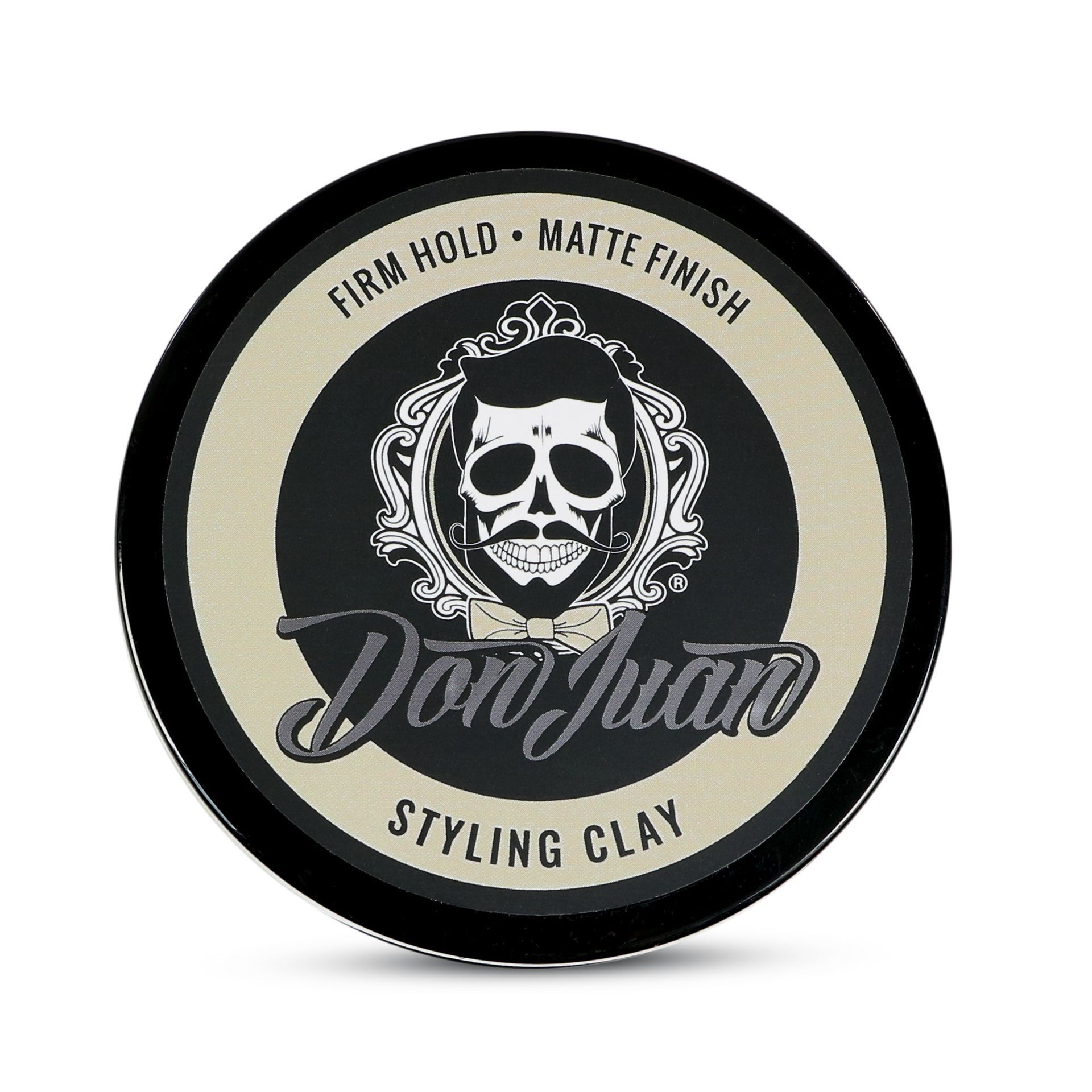 Lata redonda de arcilla para peinar Don Juan, de color negro y marrón claro, con el logo de una calavera y el texto "fijación firme, acabado mate".
