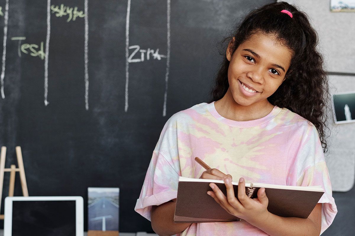 Girl in school holding a tablet computer