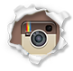 Instagram camera icon with brown and beige retro camera on torn white paper background