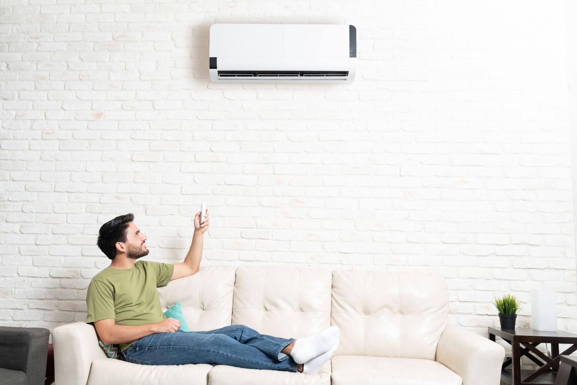 A man is turning an AC on.