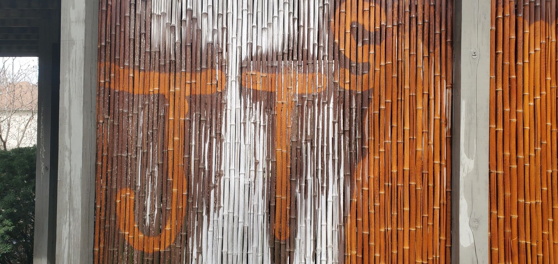 Rusty orange and white graffiti letters on a corrugated metal wall