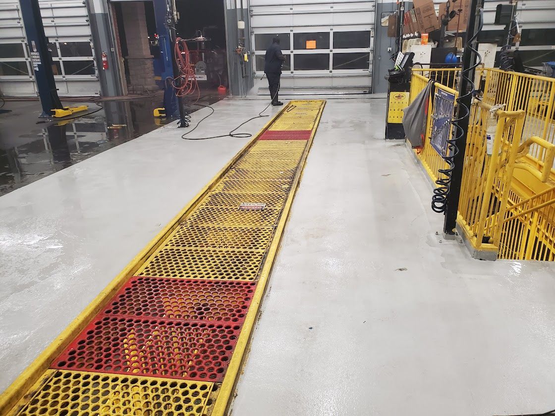 Industrial warehouse aisle with yellow and red pallet racks running down the center floor