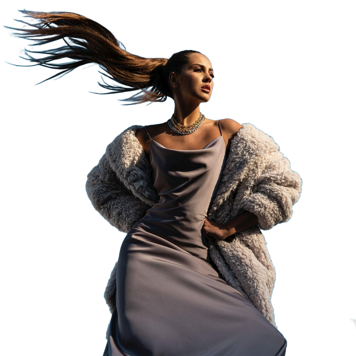 Woman in a silk dress and fur coat, hair flowing up, looking to the side.