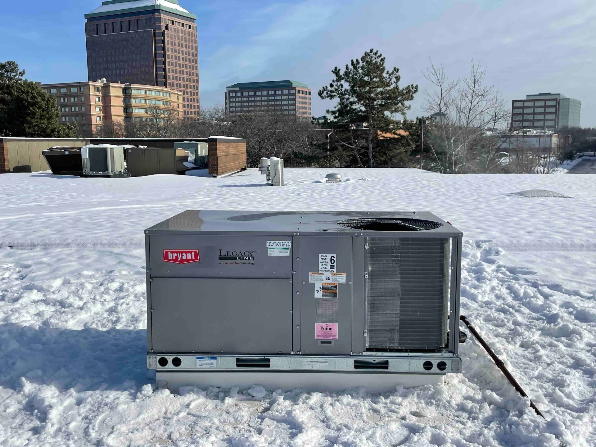 A carrier air conditioner is sitting in the snow