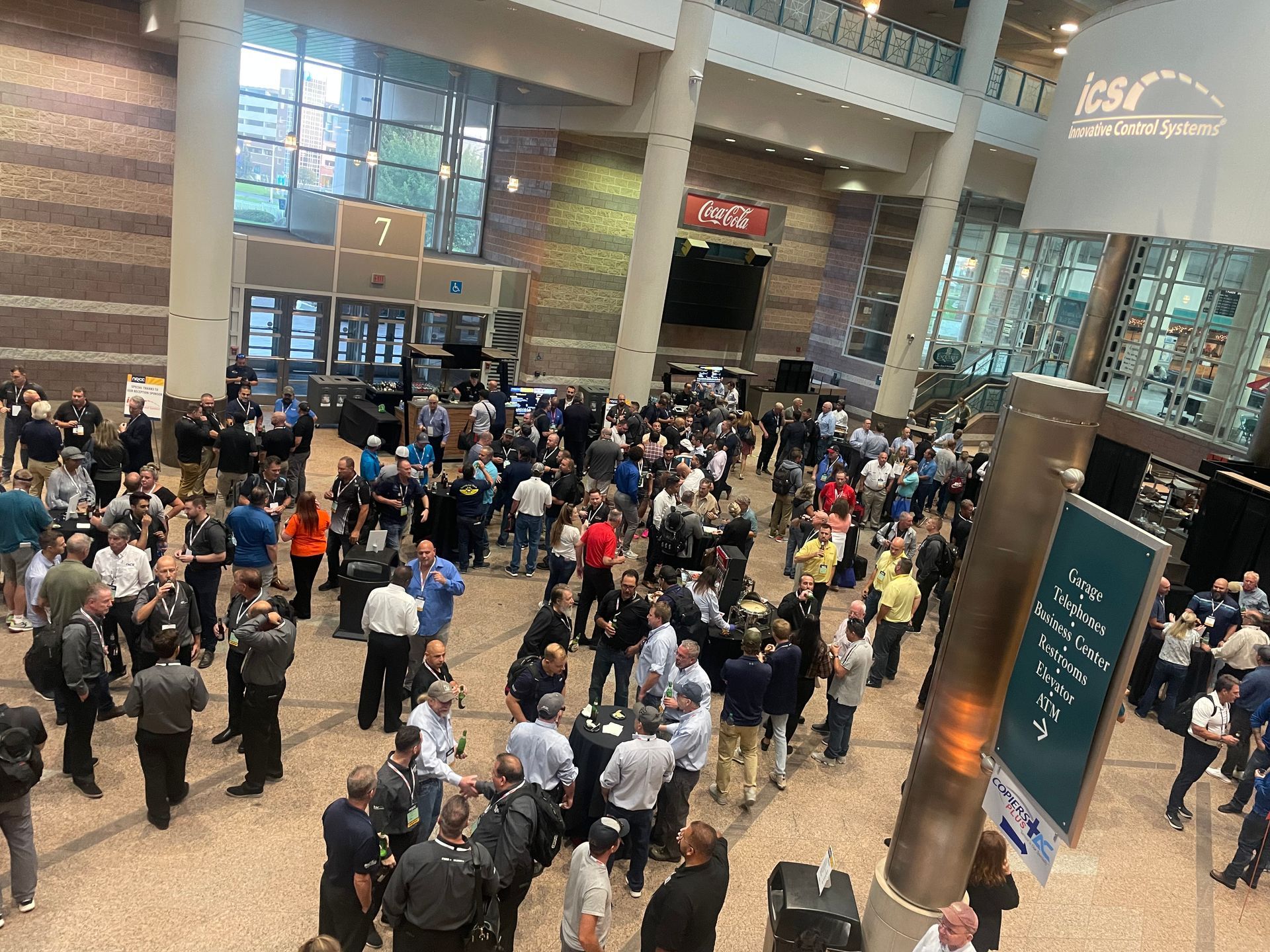 Crowded airport terminal with travelers gathered in lines near gates and check-in counters
