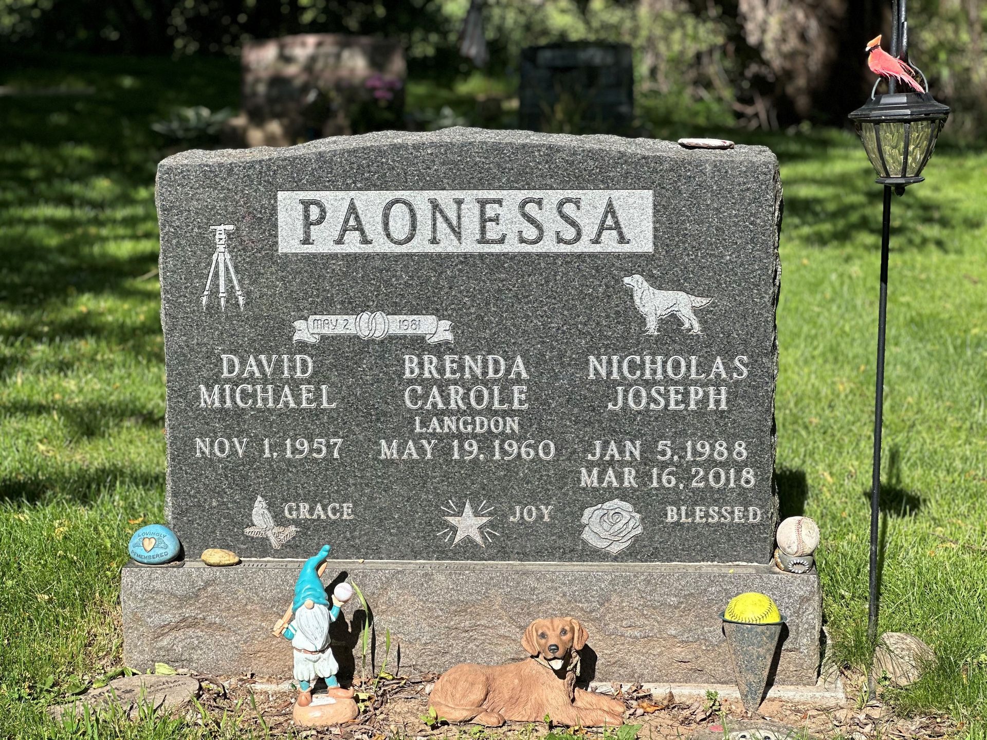 A gravestone with a dog laying on top of it in a cemetery.