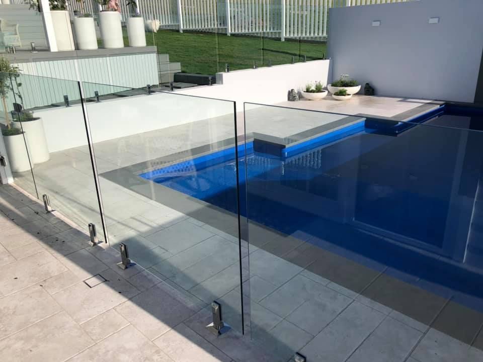 A Swimming Pool with A Glass Fence Around It — Oz-Craft in Forster, NSW