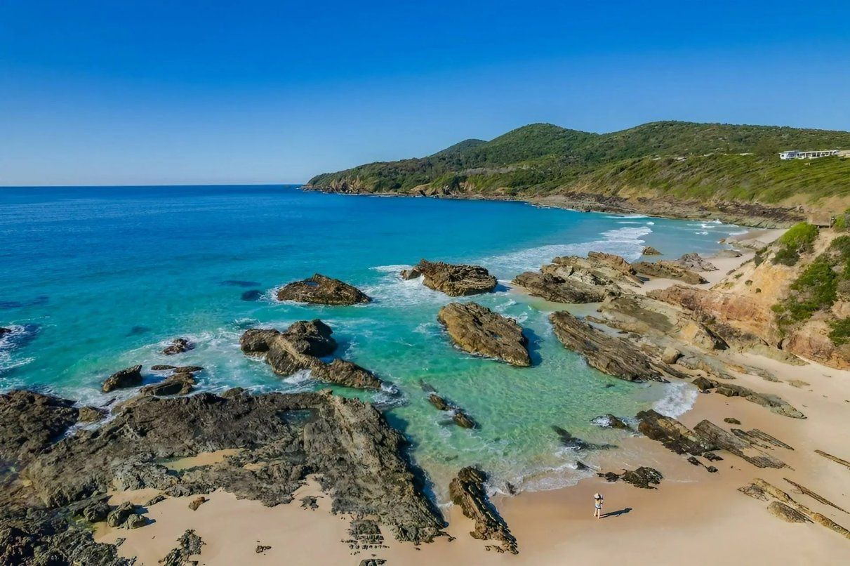 An Aerial View of A Beach with Rocks and A Body of Water — Oz-Craft in Forster, NSW