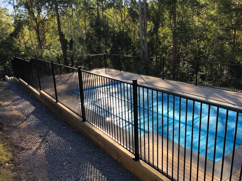 A Fence Around a Swimming Pool with Trees — Oz-Craft in Taree, NSW