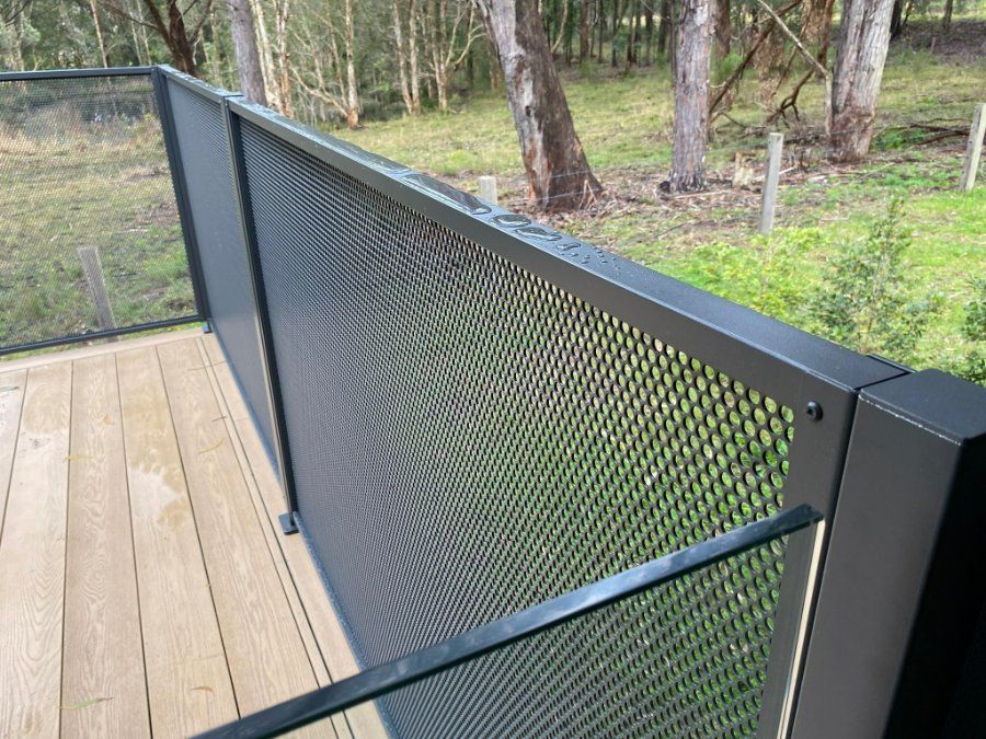 A Close up Of a Metal Railing on A Deck with Trees — Oz-Craft in Forster, NSW