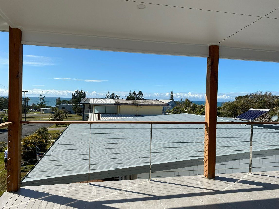 A Balcony with A View of A House and The Ocean — Oz-Craft in Port Macquarie, NSW