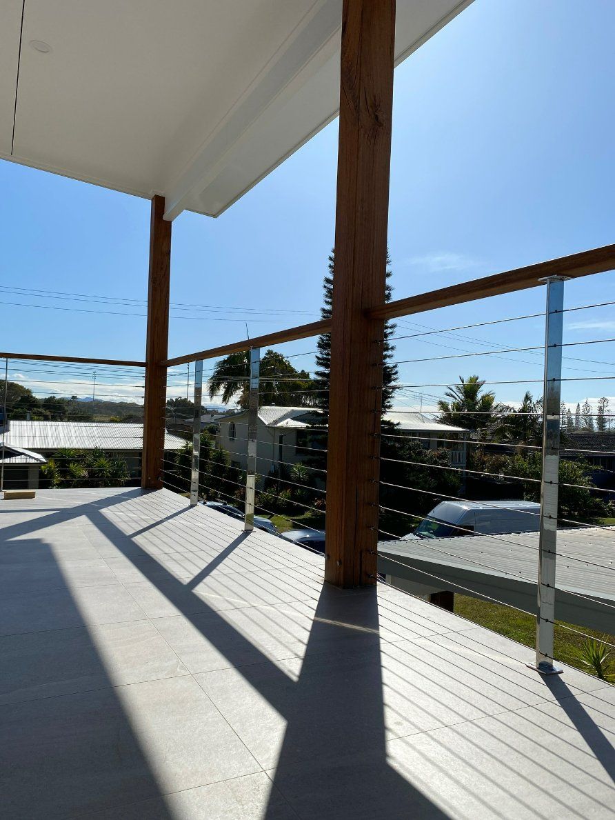 A Balcony with A Wooden Railing and A Glass Railing — Oz-Craft in Taree, NSW