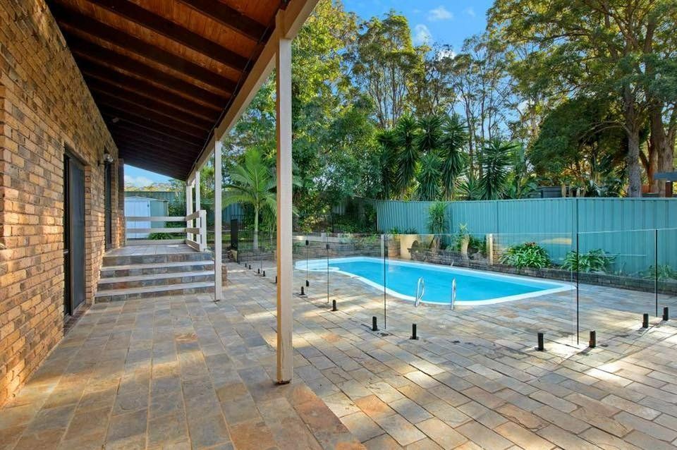 There Is a Large Swimming Pool in The Backyard of A House — Oz-Craft in Taree, NSW