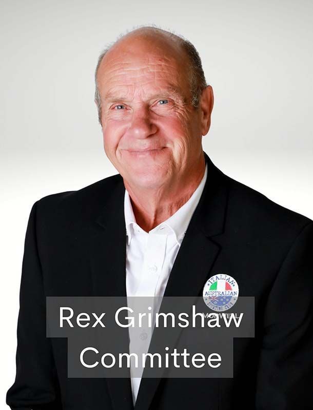 Portrait of Rex Grimshaw in a black blazer with a “Committee” label on a white background