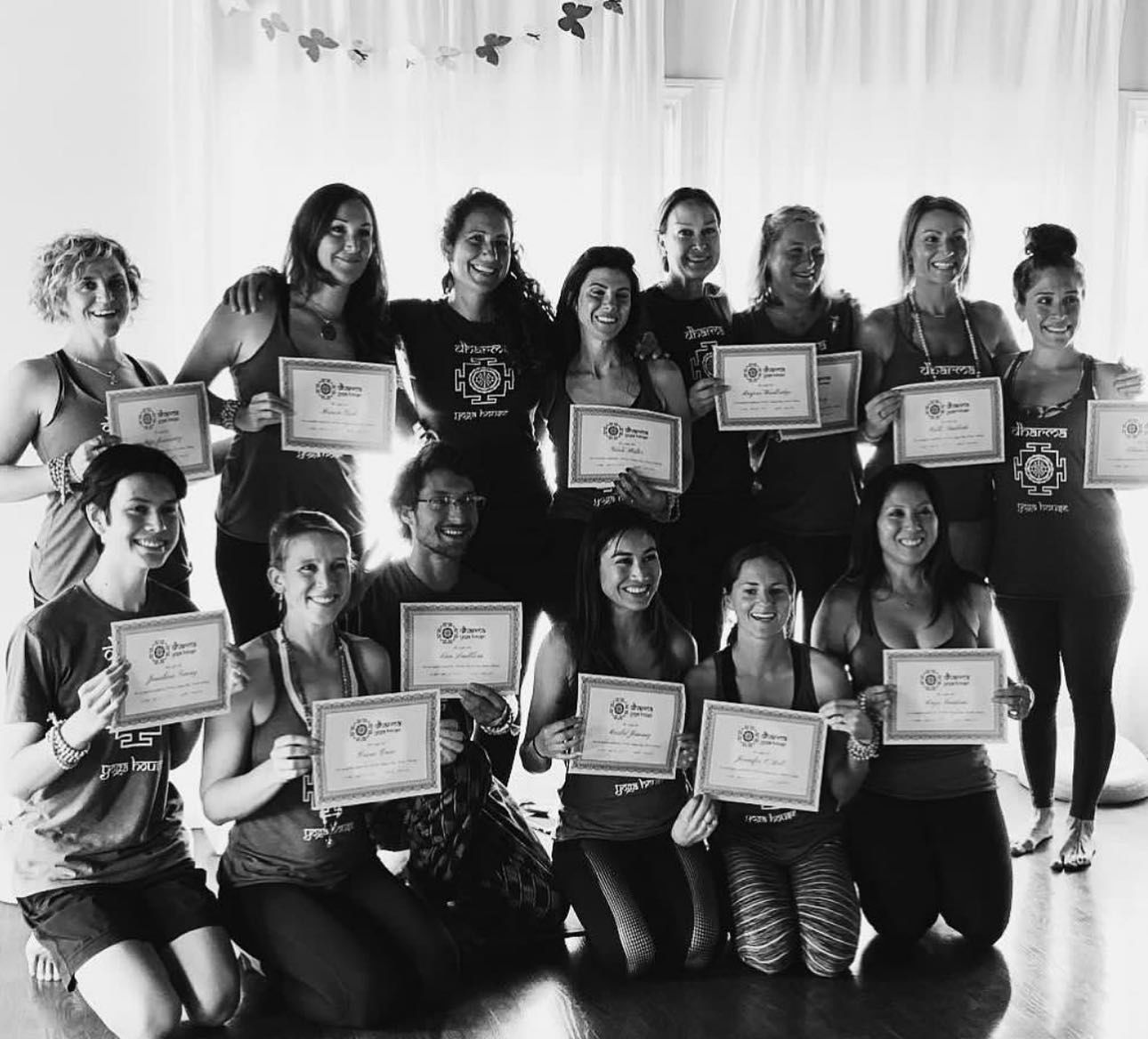 a group of people are posing for a picture holding certificates