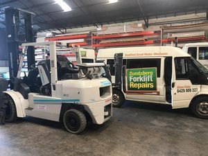 Forklift and a Van Are Parked Next to Each Other in a Garage — Bundaberg Forklift Repairs Gin Gin, QLD