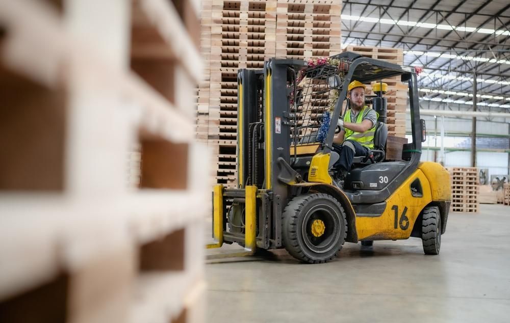 Man is Driving a Forklift in a Warehouse — Bundaberg Forklift Repairs Bundaberg North, QLD