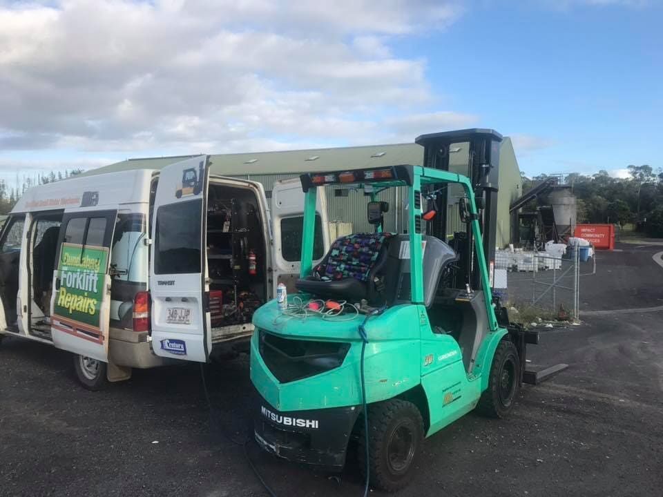 Forklift is Sitting Next to a Van in a Parking Lot — Bundaberg Forklift Repairs Maryborough, QLD