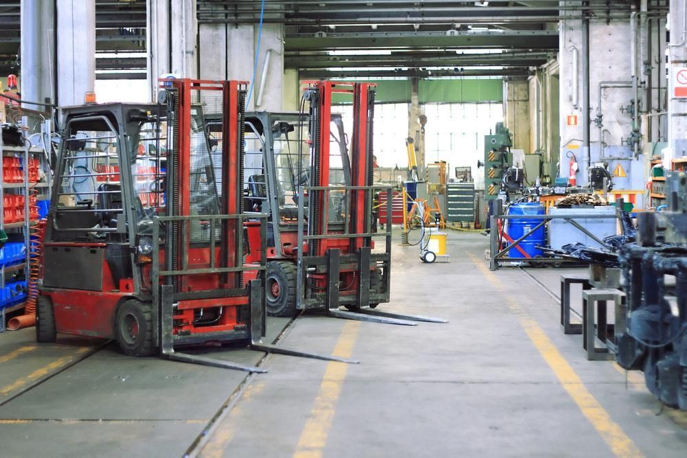Row of Forklifts Are Parked in a Factory — Bundaberg Forklift Repairs Bundaberg North, QLD