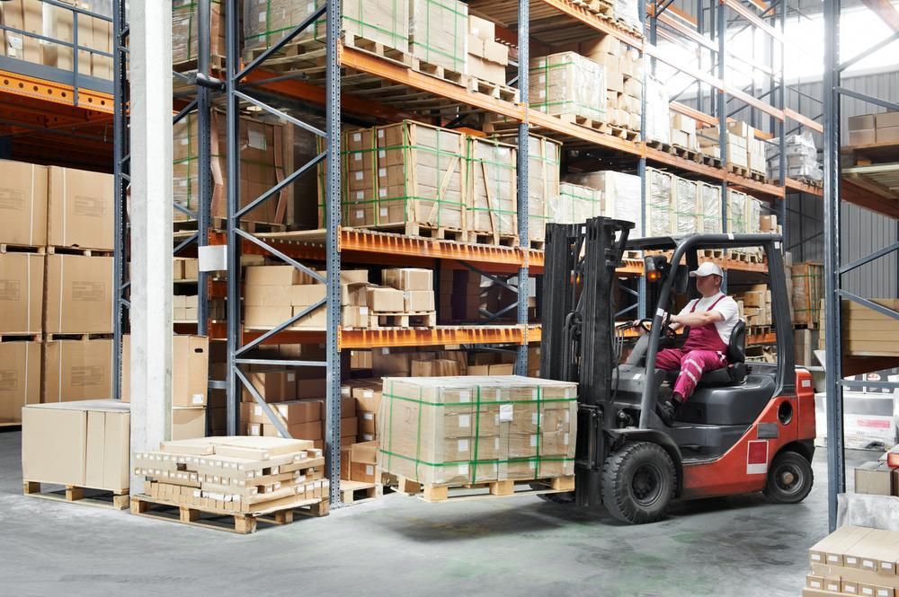 Man is Driving a Forklift in a Warehouse— Bundaberg Forklift Repairs Bundaberg North, QLD