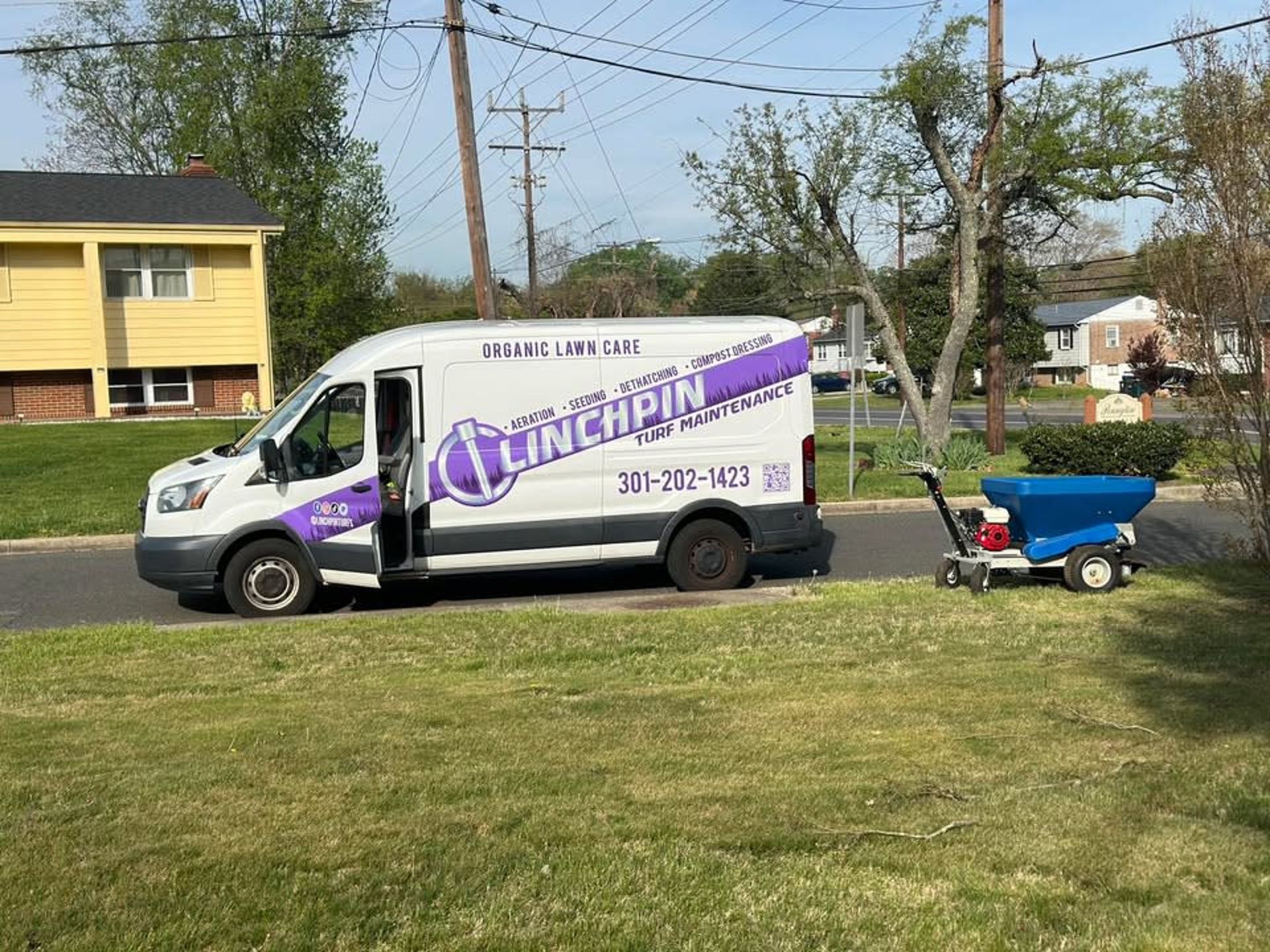A white service van with purple 
