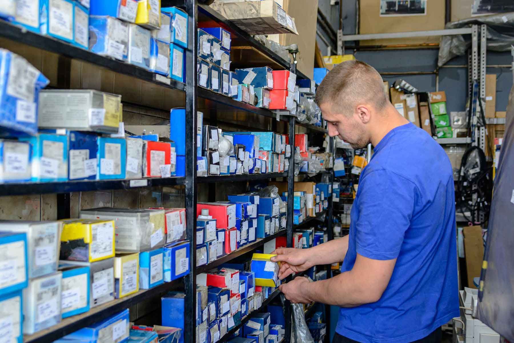 A car mechanic who is looking for a car part in a large store.