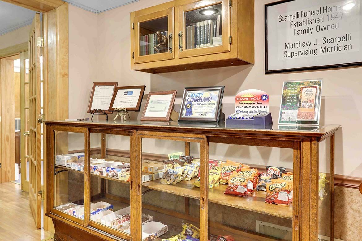 Glass display cases in a bakery or café with packaged snacks and menu signs