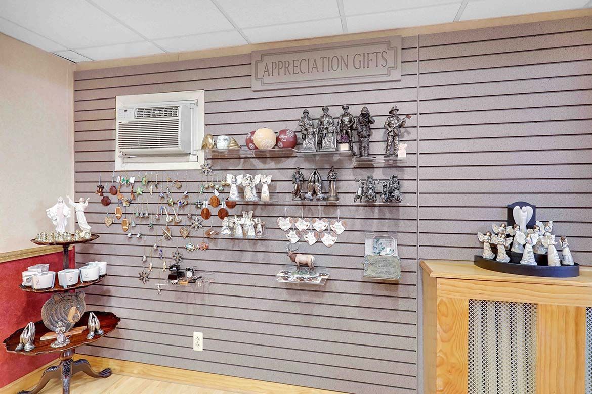 Wall display of jewelry and decorative items on slatwall shelves in a shop interior