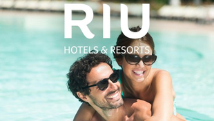 RIU Hotels & Resorts logo over a smiling couple in sunglasses by a pool