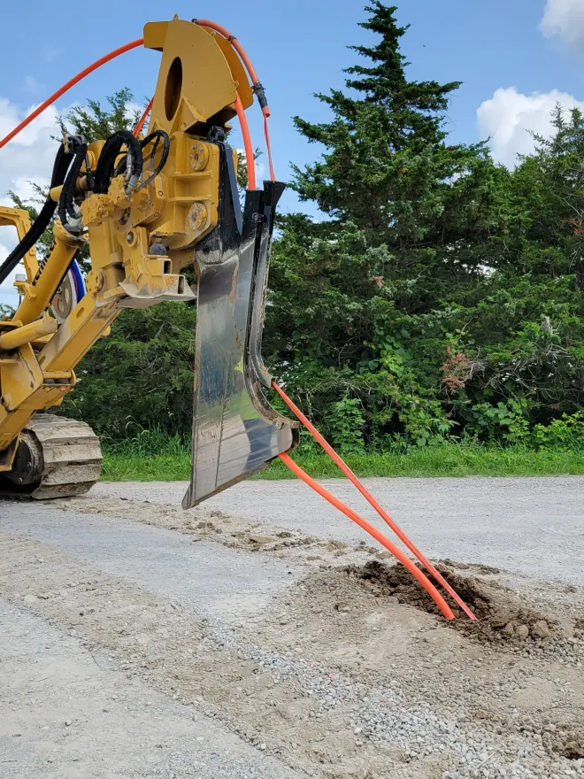 A yellow bulldozer is digging a hole in the ground